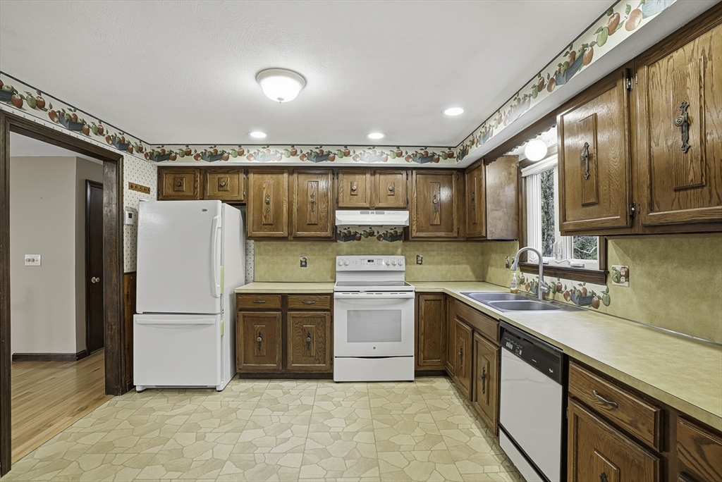 4 Carby Drive Mendon, MA 01756 - Photo 8 of 35 a kitchen with a sink a refrigerator and cabinets