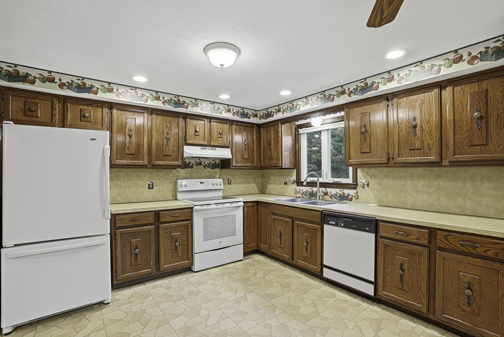 4 Carby Drive Mendon, MA 01756 - Photo 9 of 35 a kitchen with a sink window and cabinets