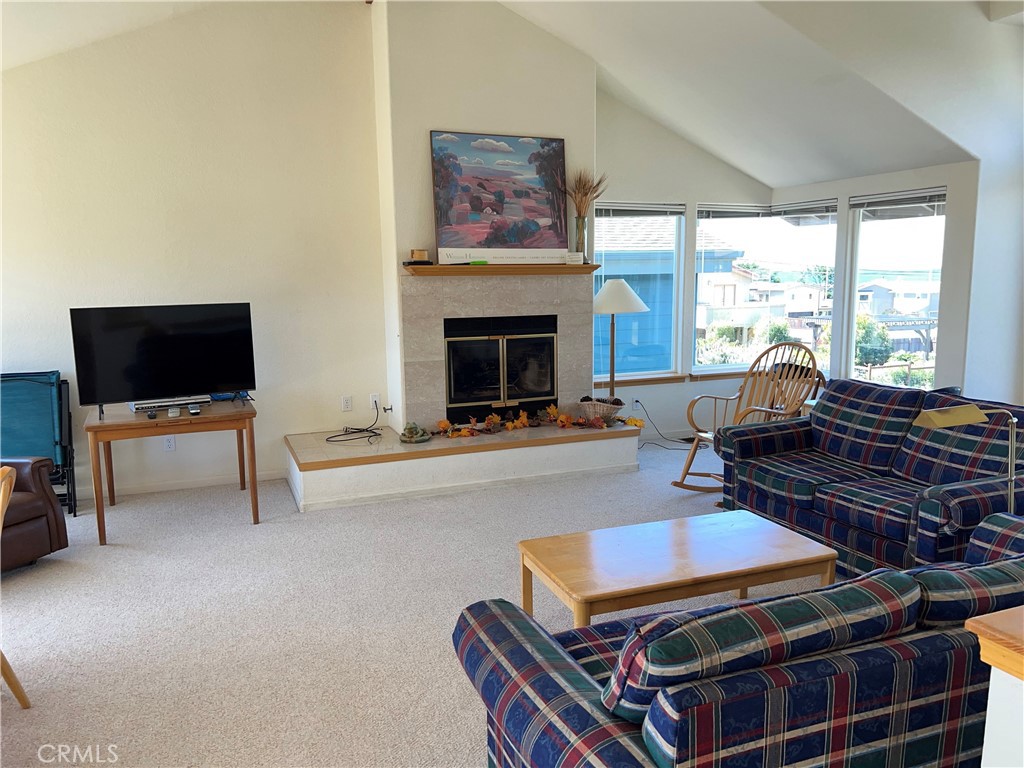 330 Jean Street Cambria, CA 93428 - Photo 12 of 75 a living room with furniture a flat screen tv and a fireplace