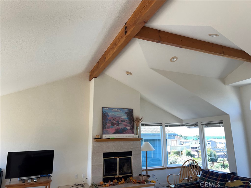 330 Jean Street Cambria, CA 93428 - Photo 19 of 75 a living room with furniture a fireplace and a flat screen tv