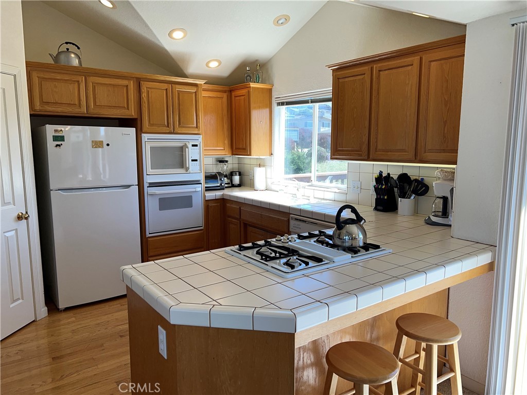 330 Jean Street Cambria, CA 93428 - Photo 26 of 75 a kitchen with a refrigerator a stove a sink and a cabinets