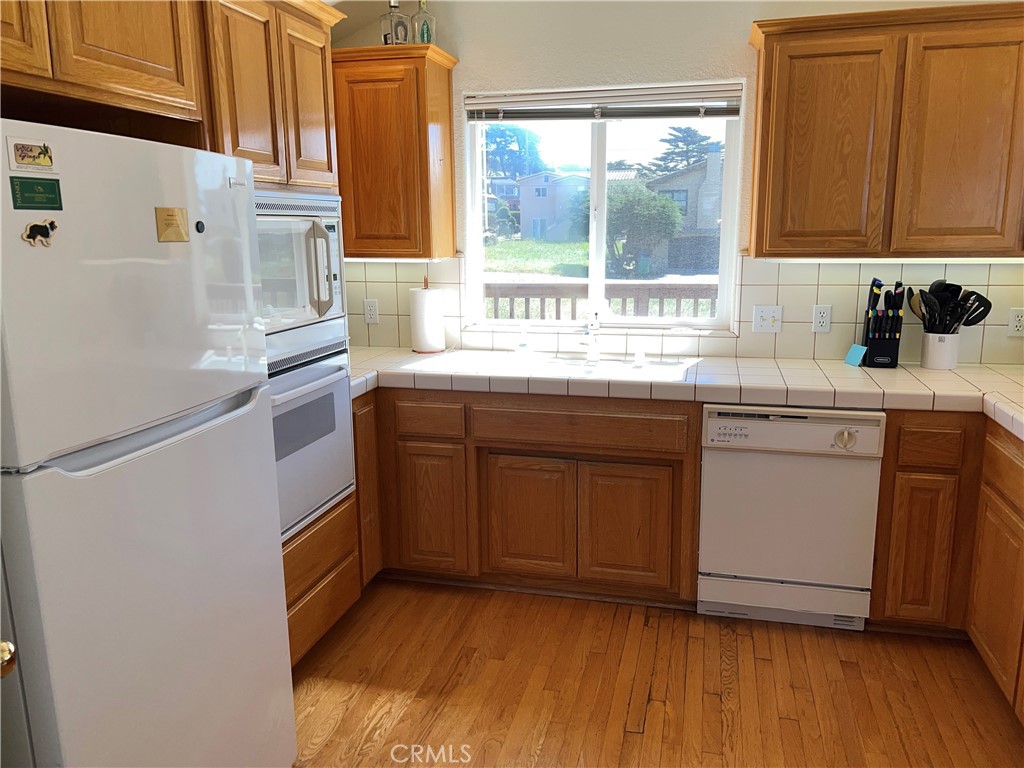 330 Jean Street Cambria, CA 93428 - Photo 27 of 75 a kitchen with a sink cabinets appliances and a window