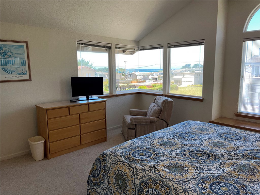 330 Jean Street Cambria, CA 93428 - Photo 31 of 75 a bedroom with a bed and a flat tv screen next to a window