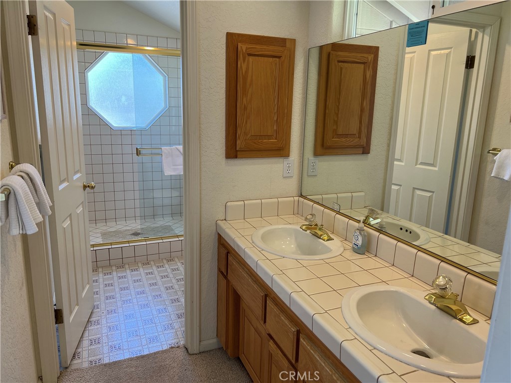 330 Jean Street Cambria, CA 93428 - Photo 33 of 75 a bathroom with a granite countertop sink and a mirror