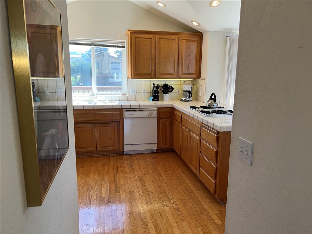 330 Jean Street Cambria, CA 93428 - Photo 39 of 75 a kitchen with stainless steel appliances granite countertop a stove a sink and a refrigerator