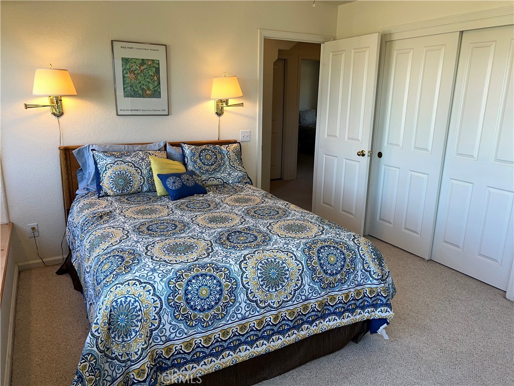 330 Jean Street Cambria, CA 93428 - Photo 43 of 75 a bedroom with a bed and a lamp