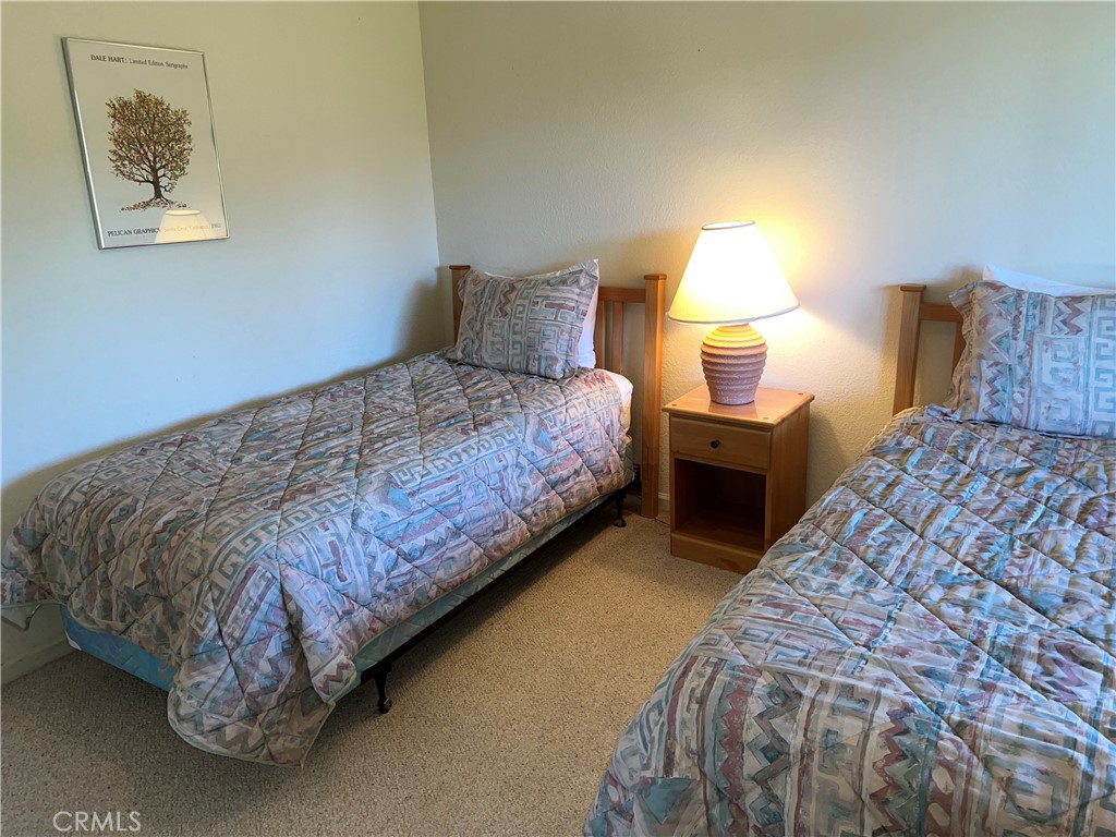 330 Jean Street Cambria, CA 93428 - Photo 48 of 75 a bedroom with a bed and lamp