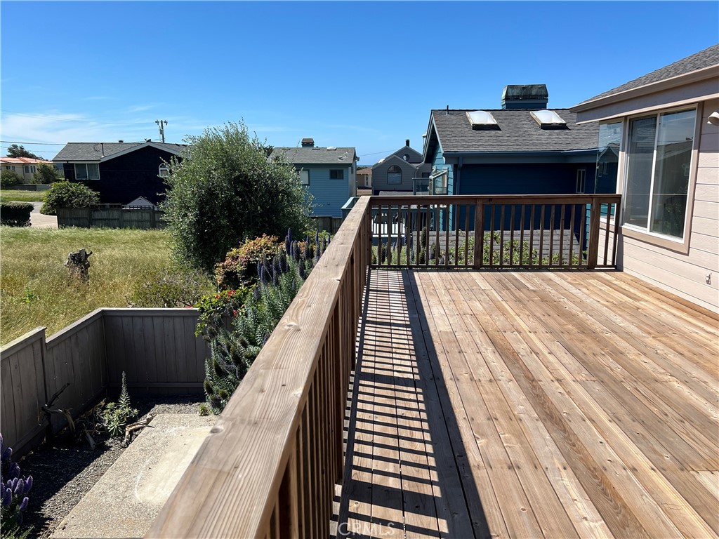 330 Jean Street Cambria, CA 93428 - Photo 55 of 75 a balcony with wooden floor outdoor seating and yard in the back