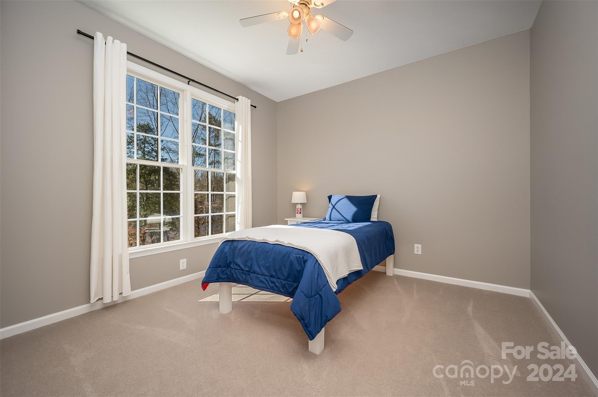 136 General Griffith Circle Rutherfordton, NC 28139 - Photo 20 of 47 a bedroom with a bed and a chandelier