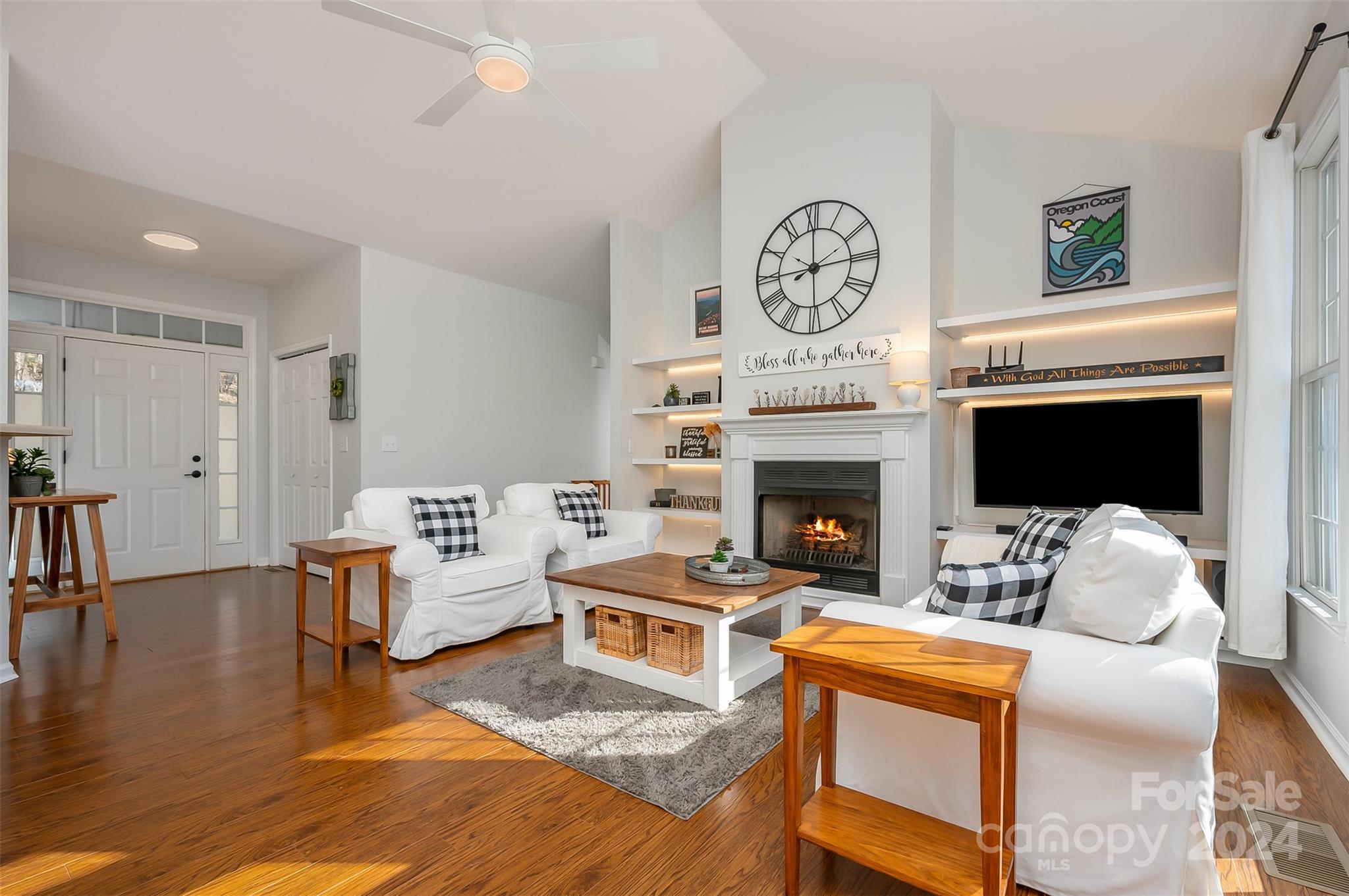 136 General Griffith Circle Rutherfordton, NC 28139 - Photo 7 of 47 a living room with furniture a clock and a fireplace