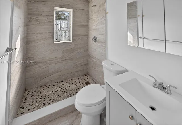 a bathroom with a sink toilet and shower