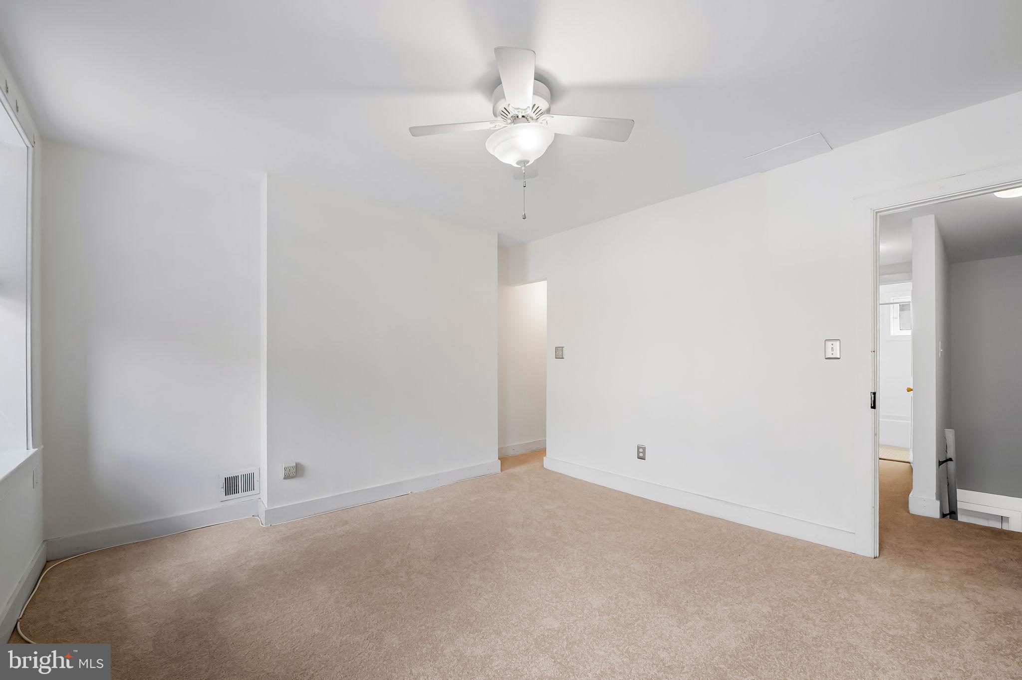 649 Portland Street Baltimore, MD 21230 - Photo 14 of 34 a view of an empty room with a ceiling fan