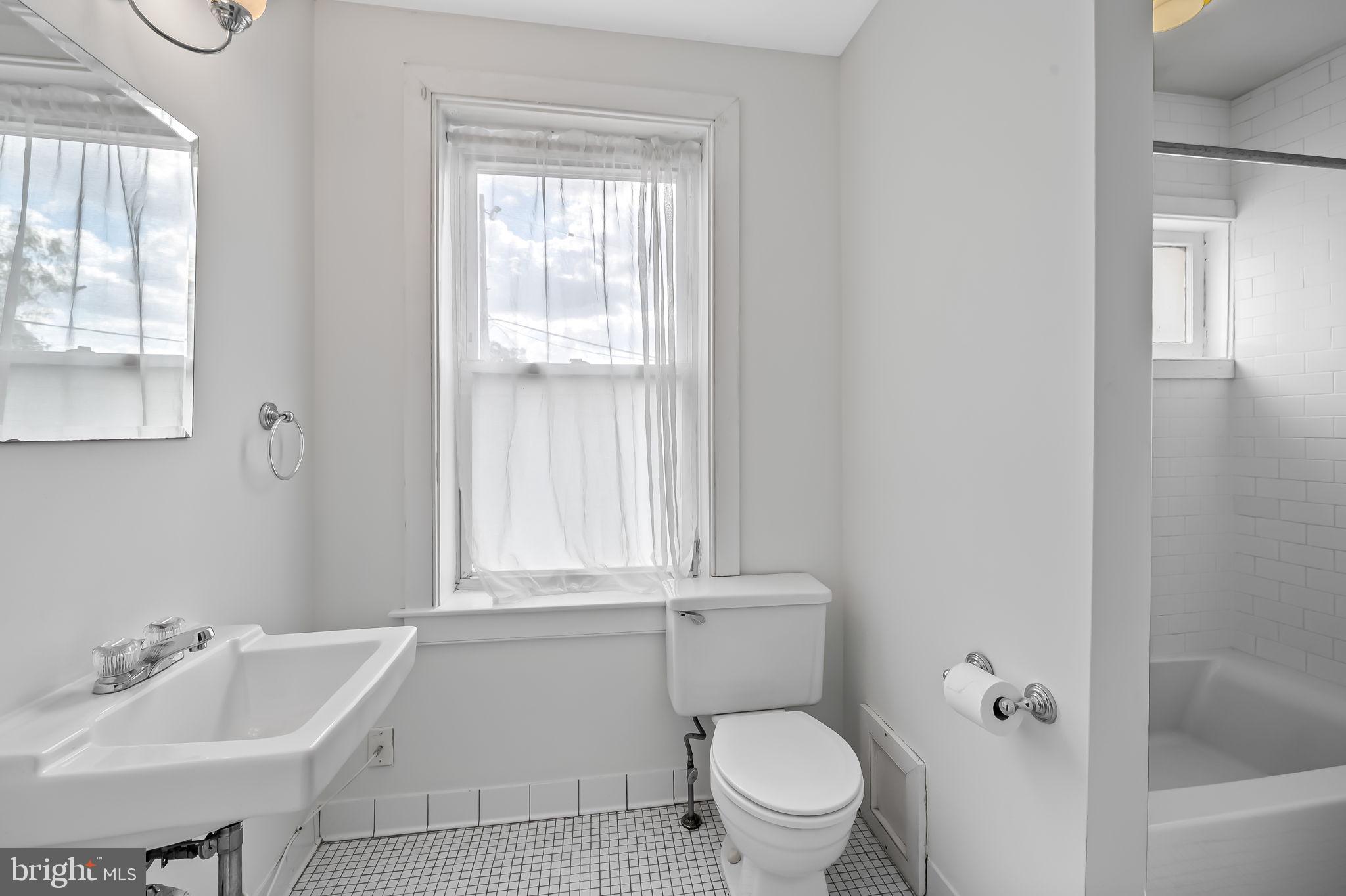 649 Portland Street Baltimore, MD 21230 - Photo 17 of 34 a bathroom with a sink toilet and shower