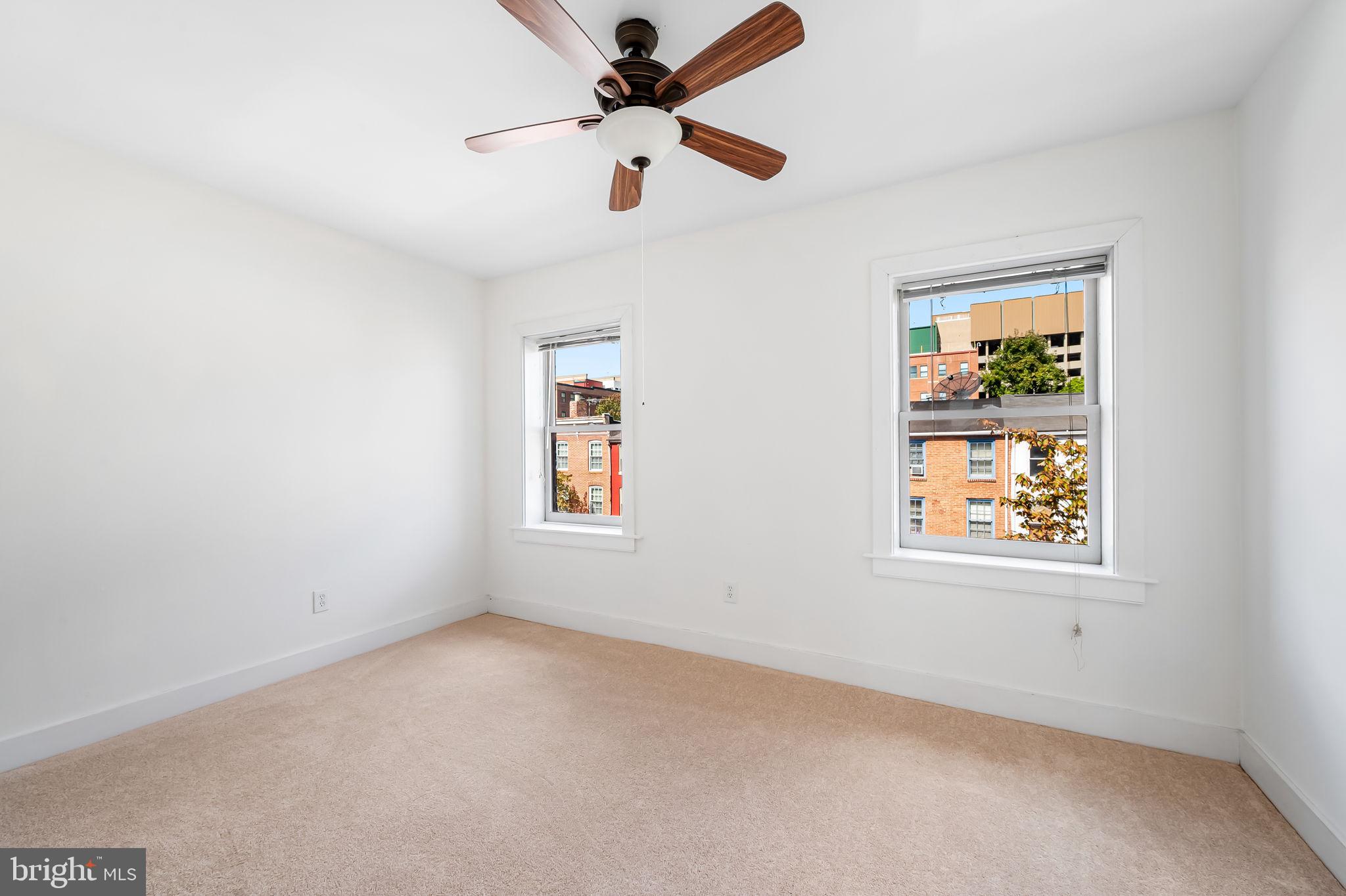 649 Portland Street Baltimore, MD 21230 - Photo 20 of 34 an empty room with windows and fan