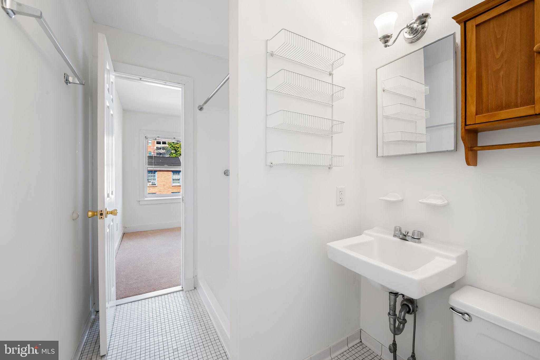 649 Portland Street Baltimore, MD 21230 - Photo 23 of 34 a bathroom with a sink and a mirror