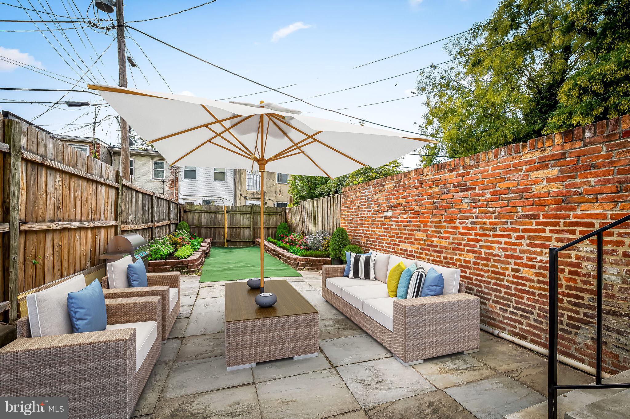649 Portland Street Baltimore, MD 21230 - Photo 31 of 34 a view of a patio with couches and a fire pit