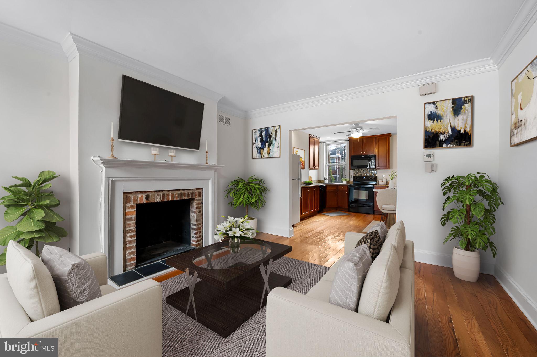649 Portland Street Baltimore, MD 21230 - Photo 4 of 34 a living room with furniture a flat screen tv and a fireplace