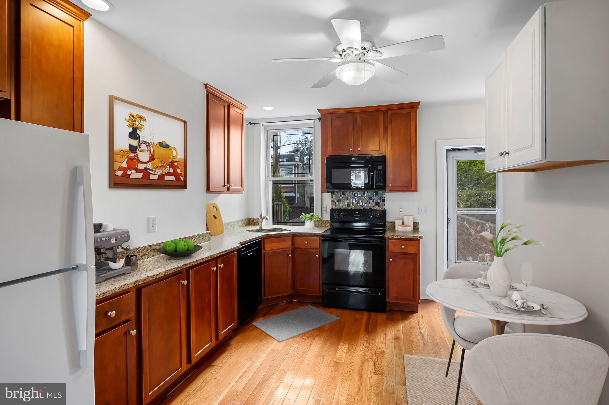 649 Portland Street Baltimore, MD 21230 - Photo 7 of 34 a kitchen with stainless steel appliances a sink stove and refrigerator