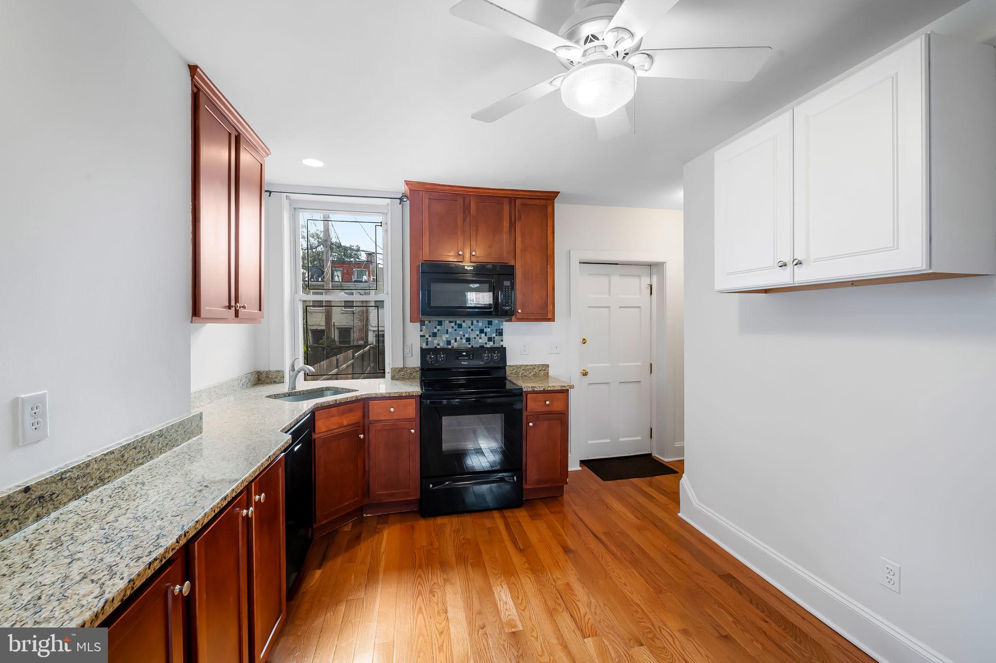 649 Portland Street Baltimore, MD 21230 - Photo 10 of 34 a kitchen with a refrigerator and a sink