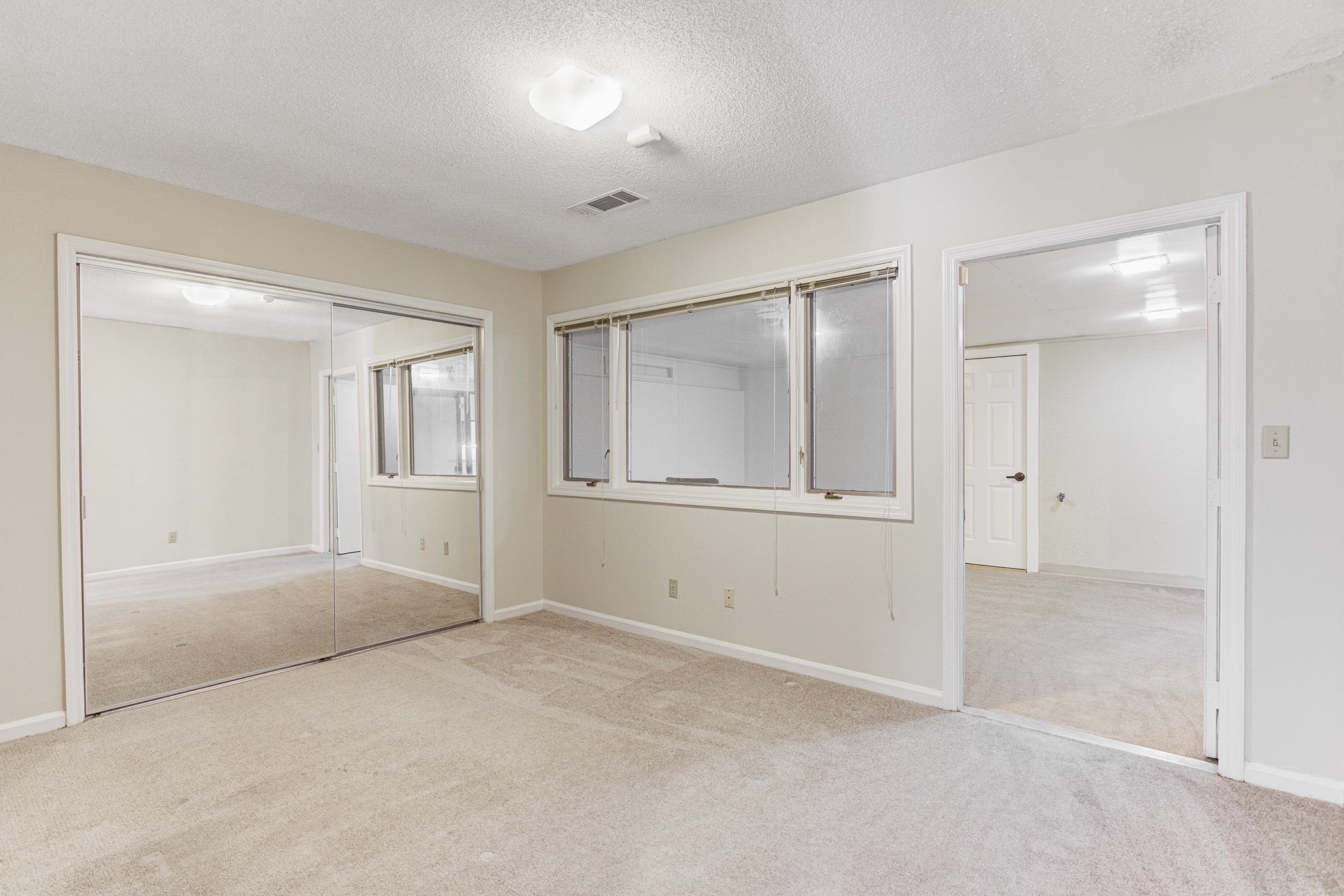 5013 Scheibler Road, Unit C1 Memphis, TN 38128 - Photo 15 of 36 Unfurnished bedroom with light colored carpet, a textured ceiling, and a closet