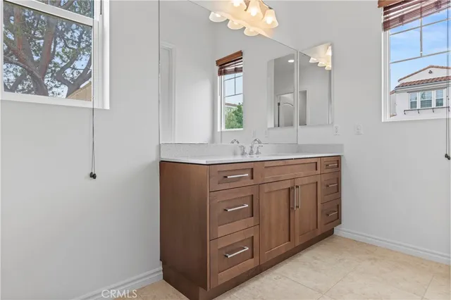 a bathroom with a granite countertop sink a mirror and a