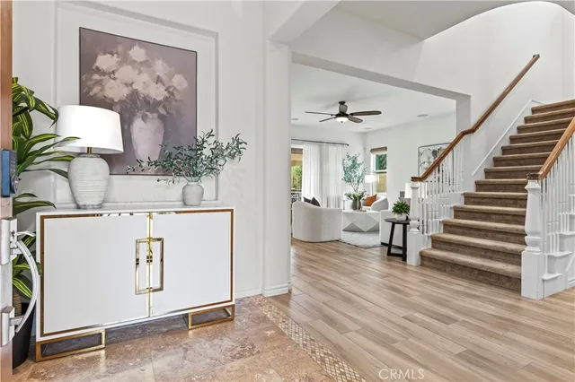 a living room with furniture and a dining table with wooden floor