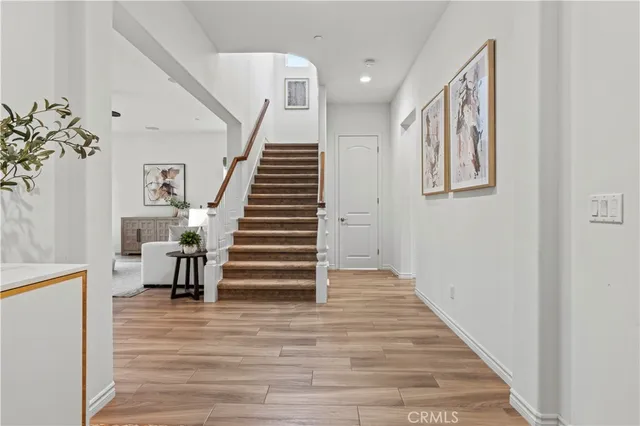 a view of entryway and hall with wooden floor