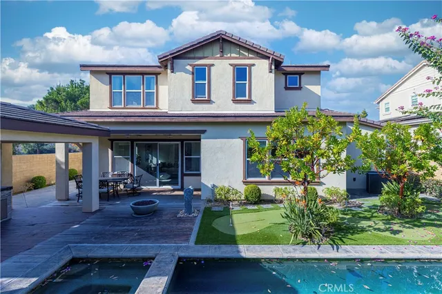 an aerial view of a house with a yard and potted plants