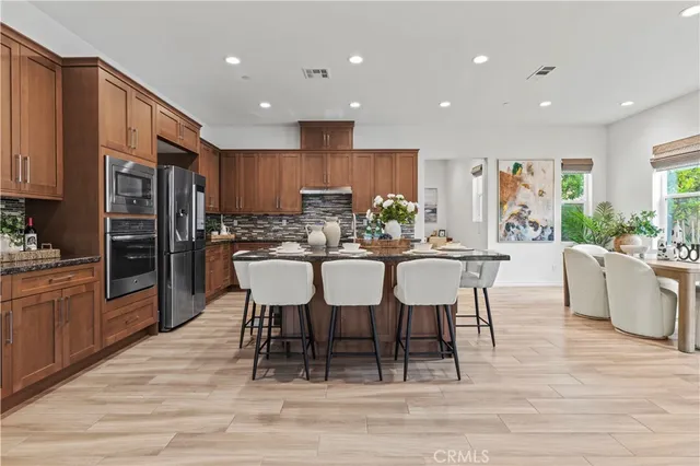 a view of kitchen with refrigerator dining table and chairs