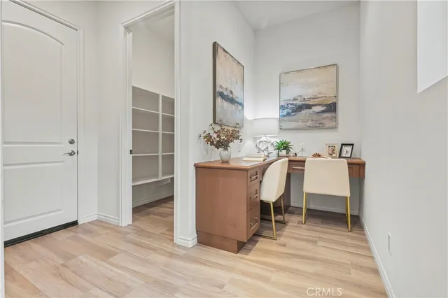 a view of a workspace with furniture and wooden floor