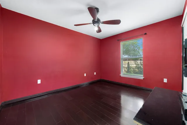a view of a room with windows and ceiling fan