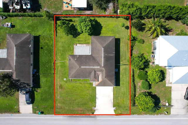 an aerial view of a house with a garden and plants