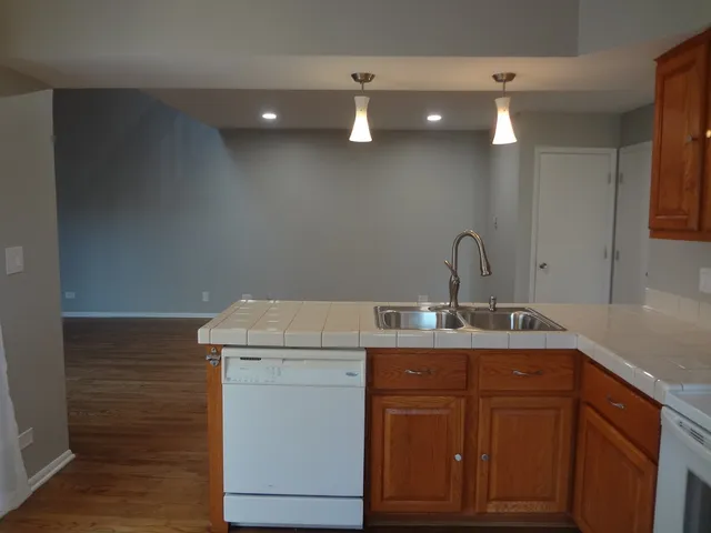 a kitchen with a sink cabinets and wooden floor