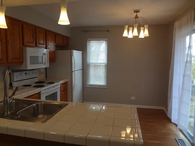 a kitchen with a sink appliances and cabinets