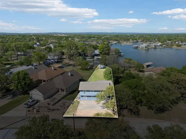 an aerial view of a house with a yard