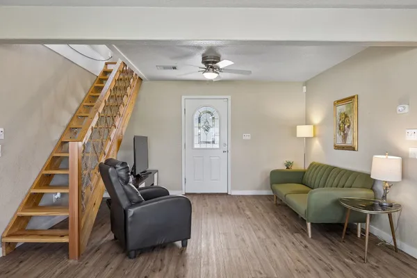 a living room with furniture and wooden floor