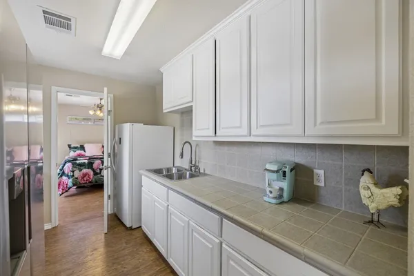 a kitchen with sink cabinets and utility