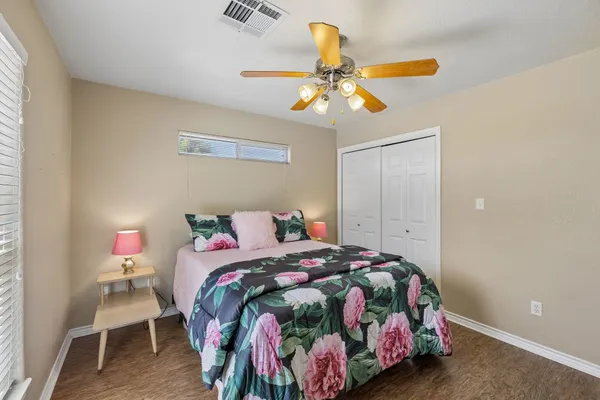 a bedroom with a bed and a chandelier