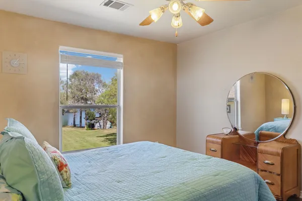 a bedroom with a bed and a mirror