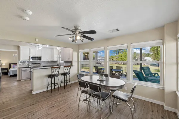a view of a dining room with furniture window and wooden floor