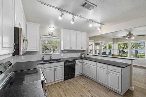 a kitchen with a sink stove and cabinets