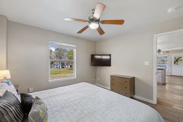 a bedroom with a bed and a tv