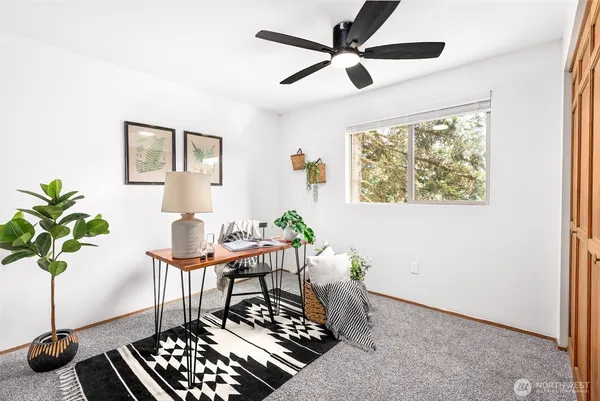 a living room with furniture and a potted plant