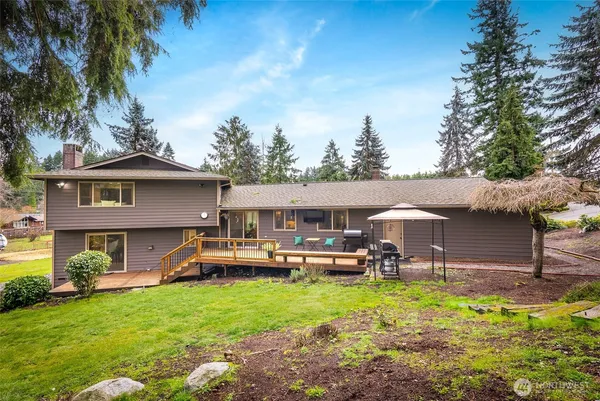 a view of a house with a backyard porch and sitting area