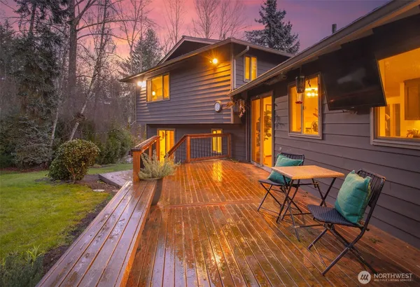 a backyard of a house with barbeque oven table and chairs