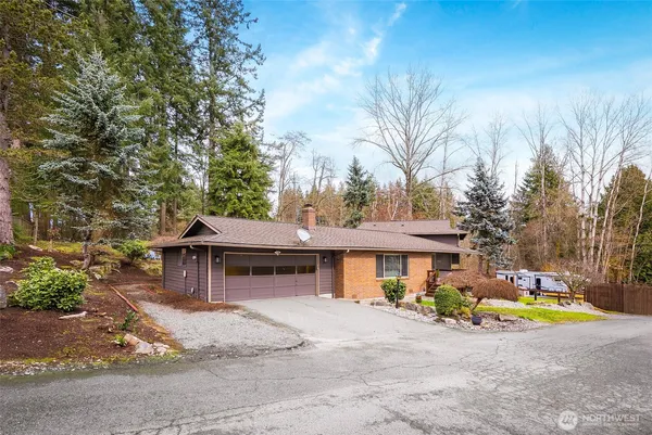 a view of a house with swimming pool and sitting area