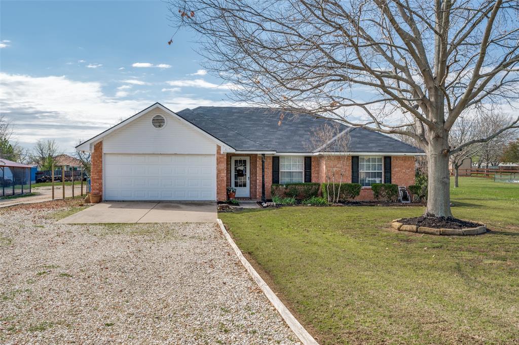 629 Concho Drive Oak Point, TX 75068 - Photo 2 of 35 a front view of a house with a yard and garage