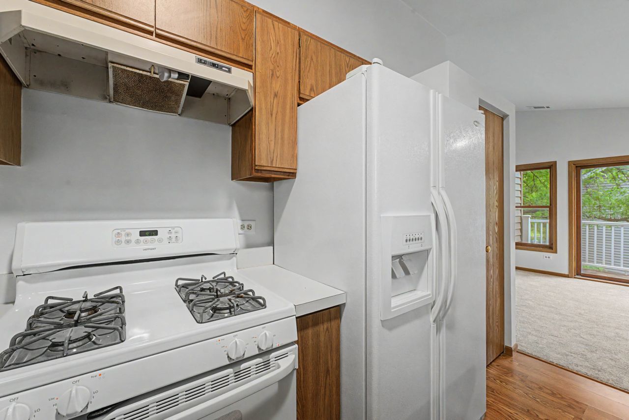 1953 North Coldspring Road Arlington Heights, IL 60004 - Photo 13 of 27 a kitchen with stainless steel appliances granite countertop a refrigerator and a stove