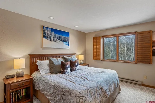 a bedroom with a large bed and a window