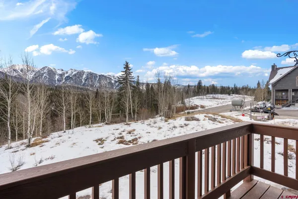 a view of a balcony with wooden fence